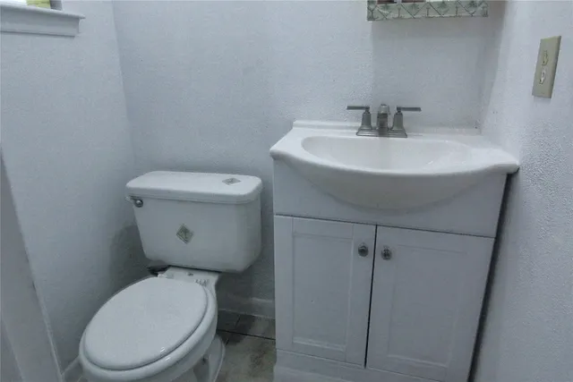 a white toilet sitting next to a bathroom sink