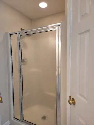 a bathroom with a glass shower door