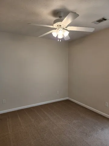 a view of an empty room with a fan