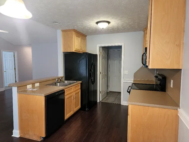 a kitchen with a stove and a refrigerator