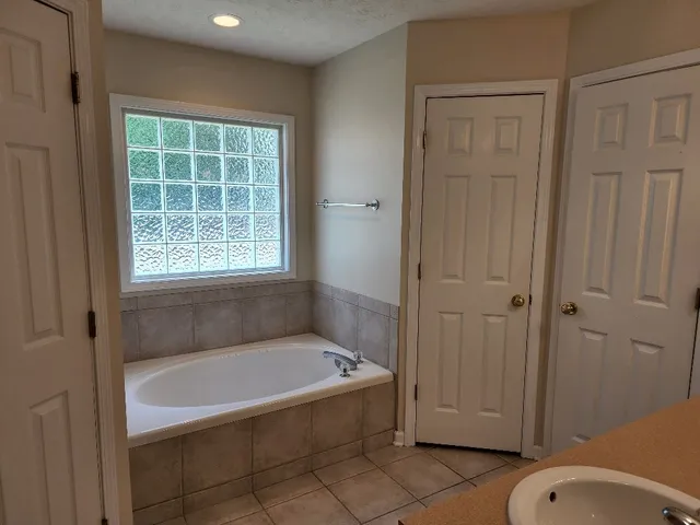 a bathroom with a granite countertop sink a toilet and shower