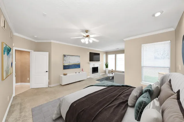 a bedroom with a large bed couch and a window