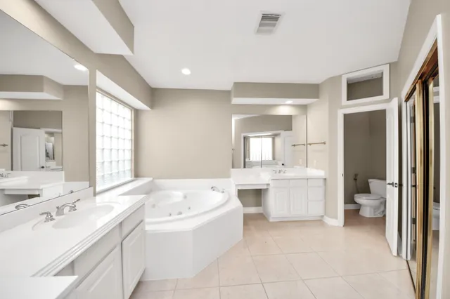 a bathroom with a bathtub shower sink and toilet