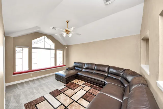a living room with furniture and a large window