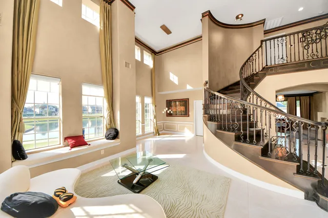 a living room with fireplace furniture and a large window