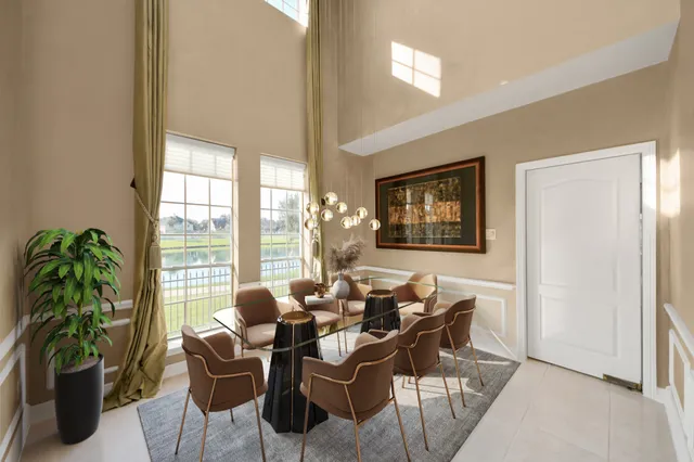 a dining room with furniture and a potted plant