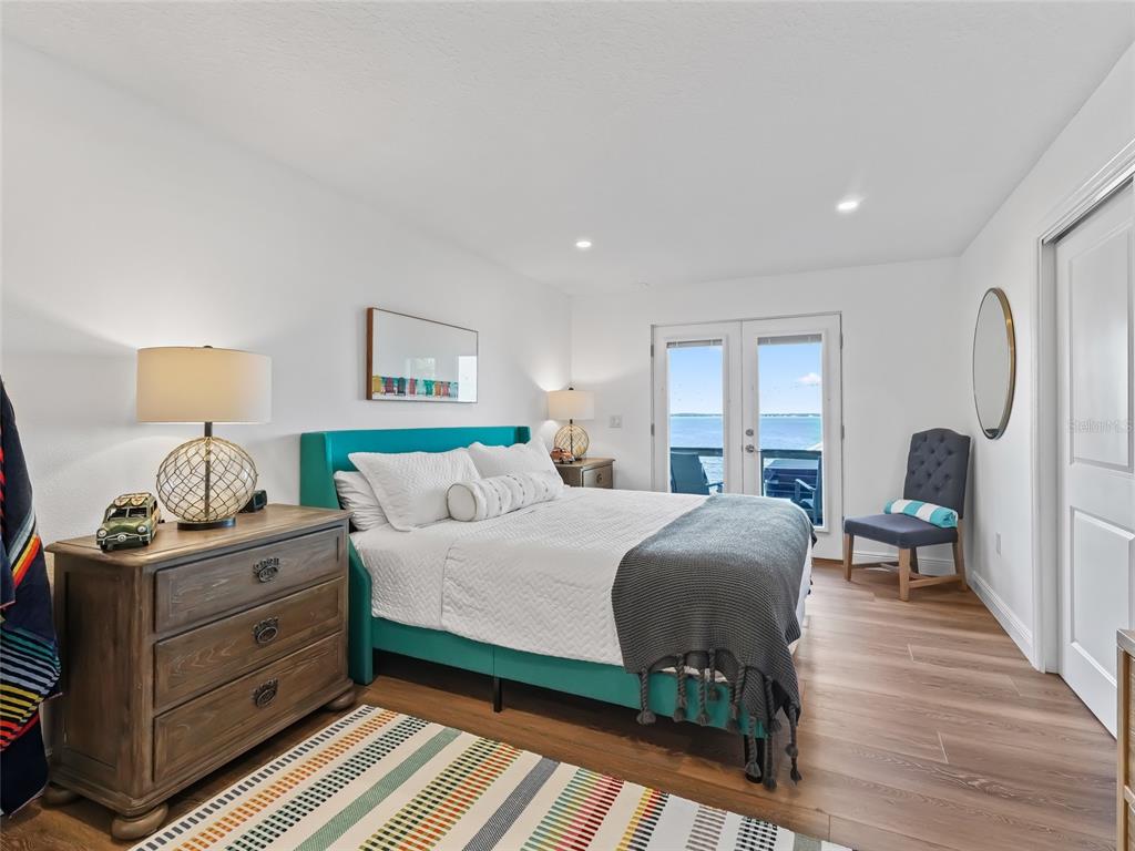 12943 Southeast Sunset Harbor Road Weirsdale, FL 32195 - Photo 72 of 87 a bedroom with a bed and wooden floor