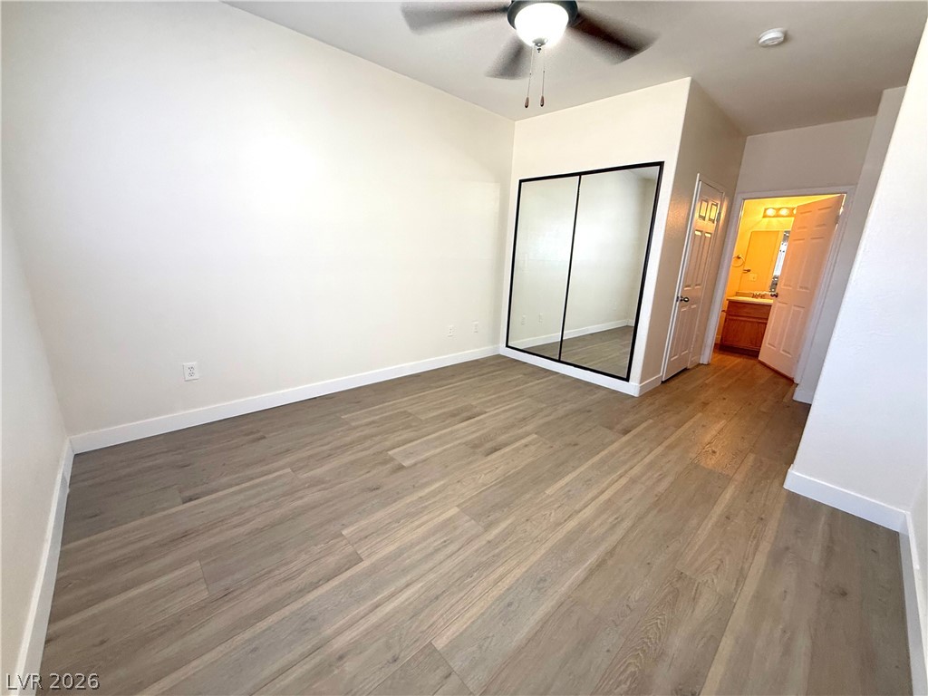 4730 East Craig Road, Unit 1164 Las Vegas, NV 89115 - Photo 12 of 14 A versatile bedroom offering ample natural light, durable flooring, and convenient mirrored closet doors.
