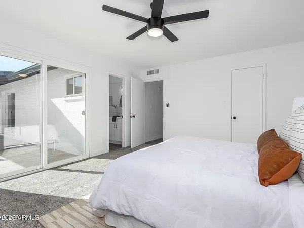 a bedroom with a bed and ceiling fan