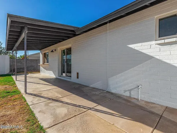 a backyard of a house with wooden floor and fence