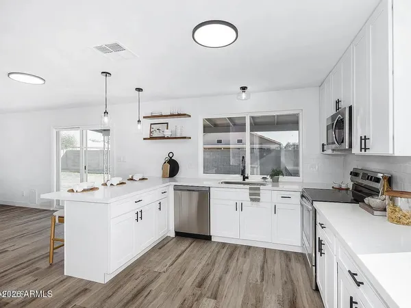 a kitchen that has a sink and a stove in it