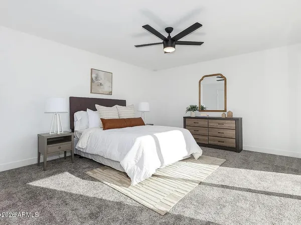 a bedroom with a bed and a painting on the wall