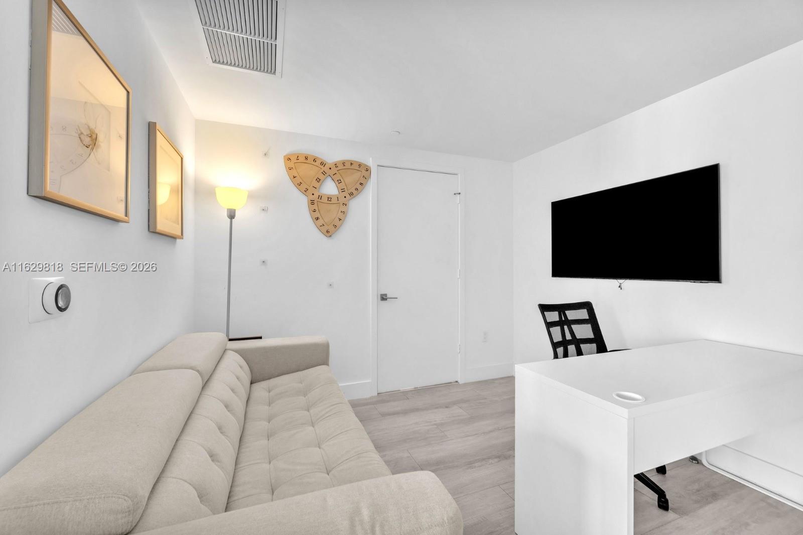 121 Northeast 34th Street, Unit 905 Miami, FL 33137 - Photo 5 of 26 SOFA BED, TV. AND ATTACHED FULL BATHROOM