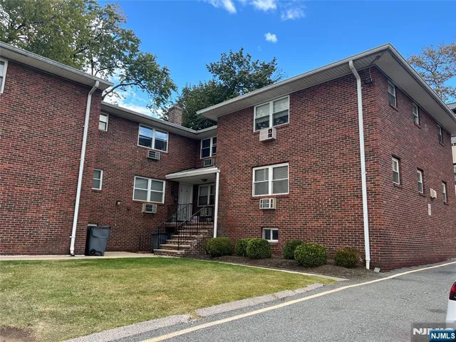 a view of a brick house with a yard