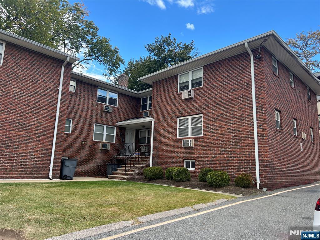 275 River Road, Unit K Bogota, NJ 07603 - Photo 1 of 8 a view of a brick house with a yard