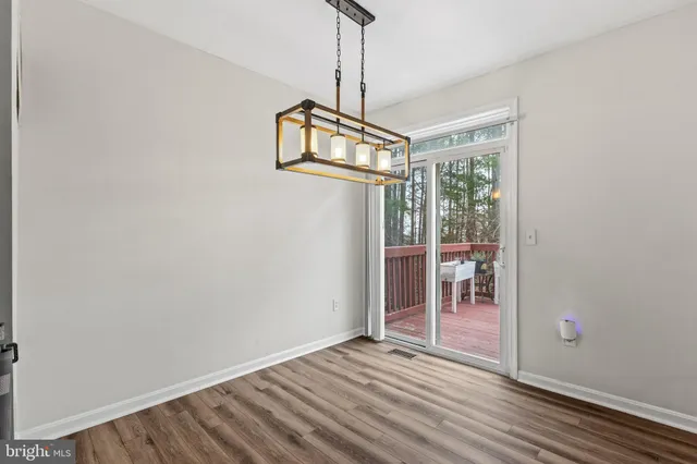 a view of a room with wooden floor and fan
