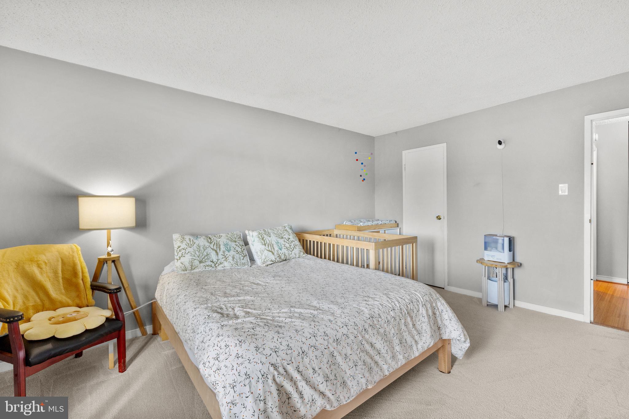 4500 South Four Mile Run Drive, Unit 222 Arlington, VA 22204 - Photo 16 of 41 a bedroom with a bed and a chair