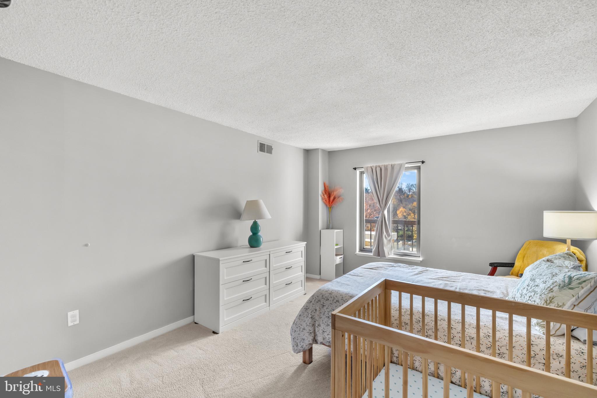 4500 South Four Mile Run Drive, Unit 222 Arlington, VA 22204 - Photo 17 of 41 a bedroom with furniture and a window