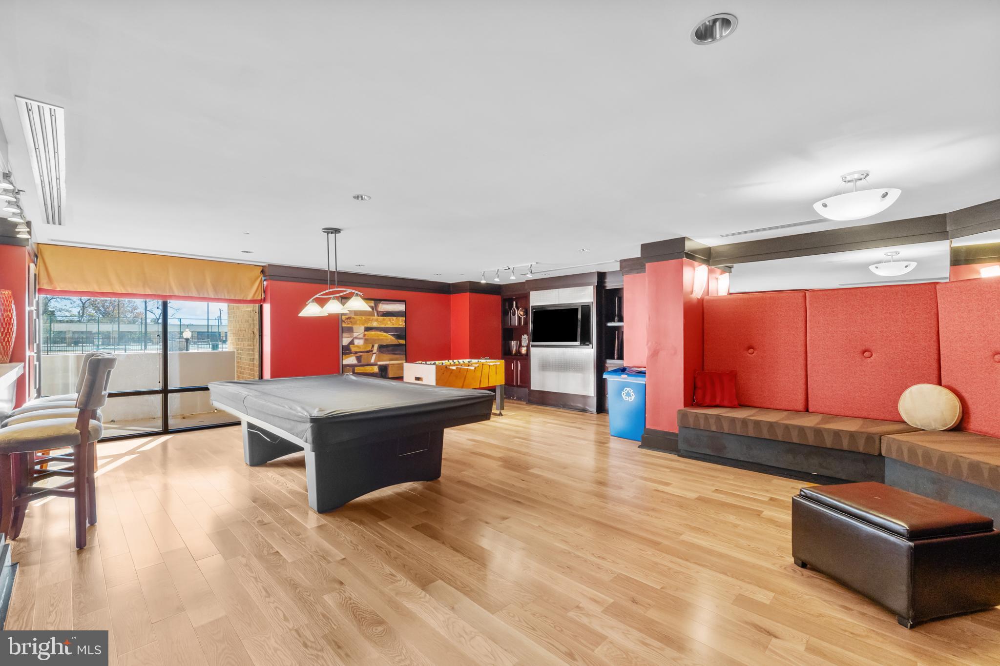 4500 South Four Mile Run Drive, Unit 222 Arlington, VA 22204 - Photo 29 of 41 a living room with furniture a flat screen tv and a large window