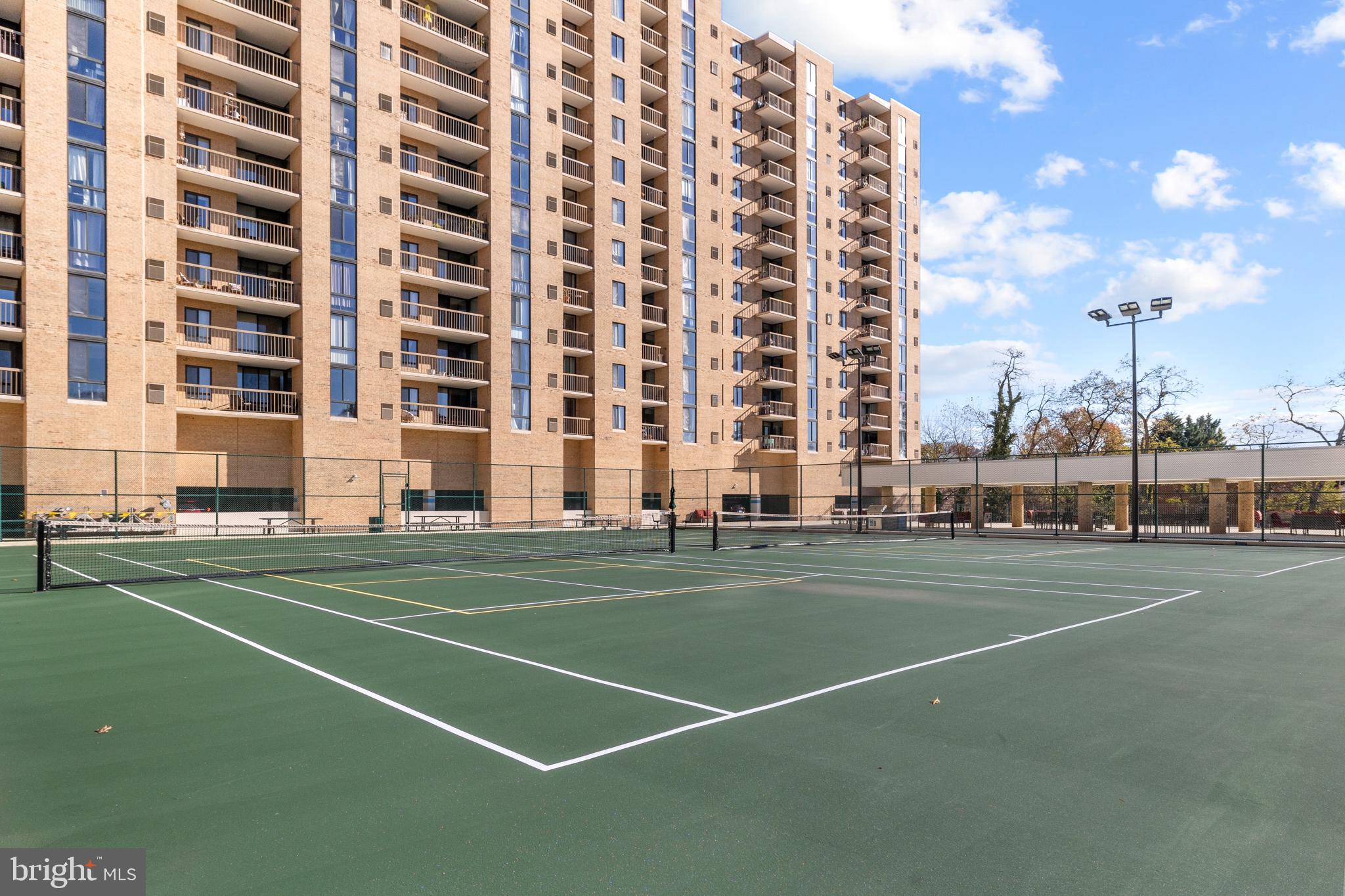 4500 South Four Mile Run Drive, Unit 222 Arlington, VA 22204 - Photo 33 of 41 a view of a tall building with a tall trees