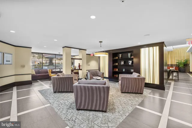 a living room with furniture and chandelier