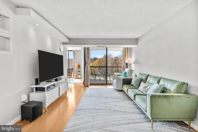 a living room with furniture tv and a large window