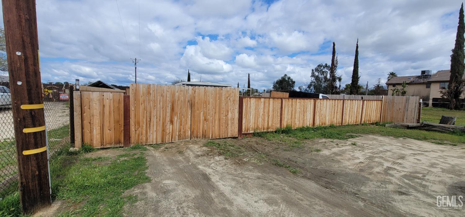 Undisclosed Address Bakersfield, CA 93312 - Photo 2 of 26 a view of a backyard with wooden fence