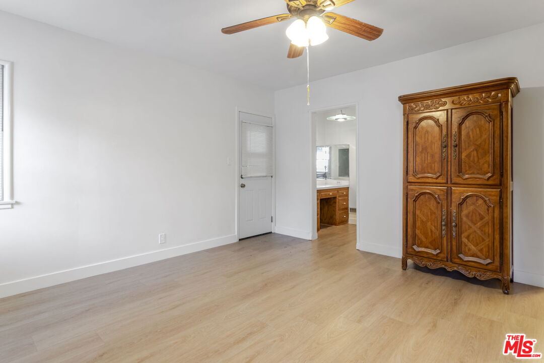 2302 Bagley Avenue Los Angeles, CA 90034 - Photo 13 of 20 an empty room with chandelier fan and stainless steel appliances