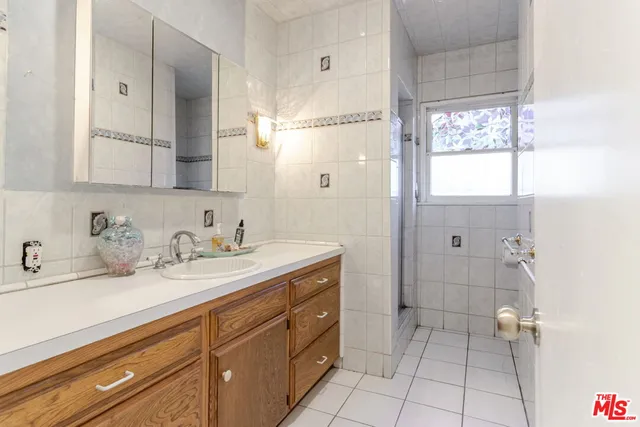 a bathroom with a granite countertop sink mirror and double