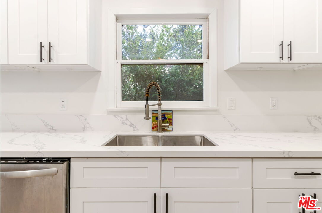 2302 Bagley Avenue Los Angeles, CA 90034 - Photo 3 of 20 a kitchen with a sink and a window