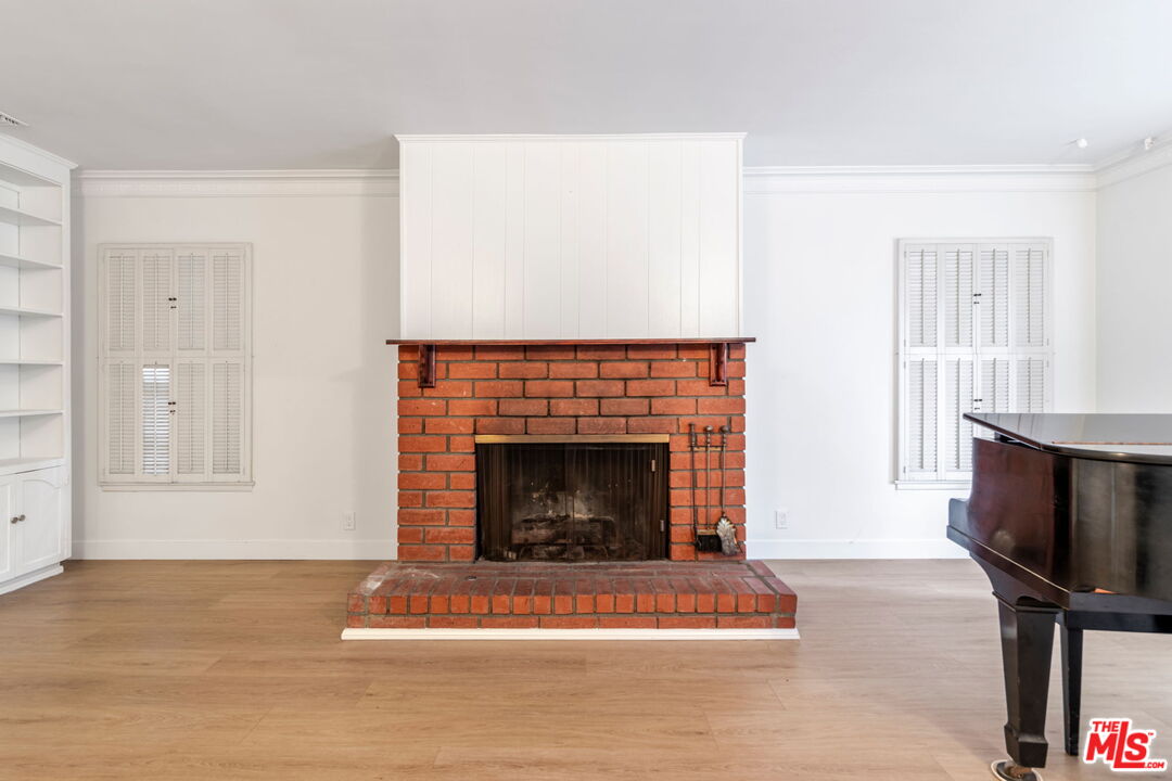 2302 Bagley Avenue Los Angeles, CA 90034 - Photo 5 of 20 a living room with furniture a fireplace and a flat screen tv