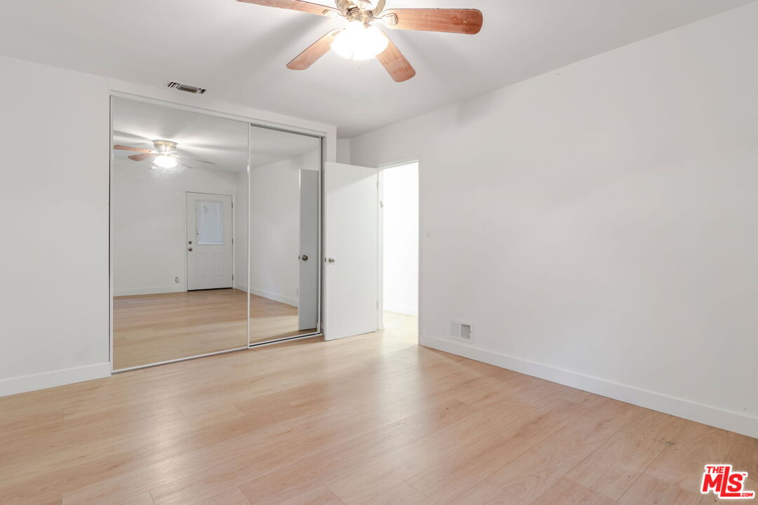 2302 Bagley Avenue Los Angeles, CA 90034 - Photo 8 of 20 an empty room with wooden floor and windows