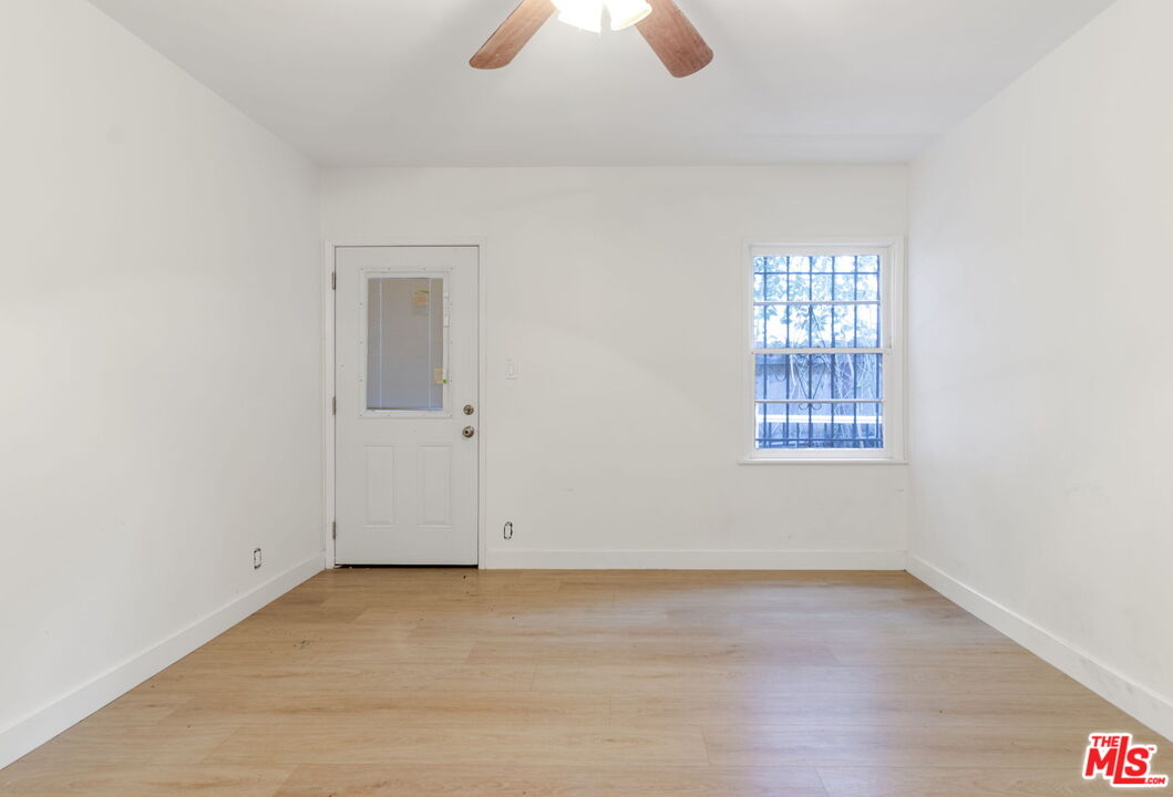 2302 Bagley Avenue Los Angeles, CA 90034 - Photo 9 of 20 an empty room with windows and chandelier fan