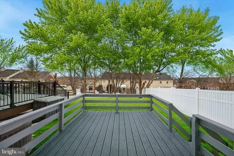a view of deck with a yard and wooden fence