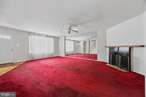 a bed room with a bed and a ceiling fan