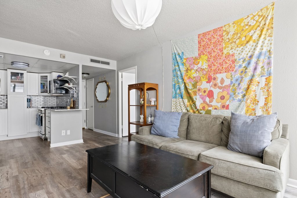 Living room with light wood finished floors and a textured ceiling