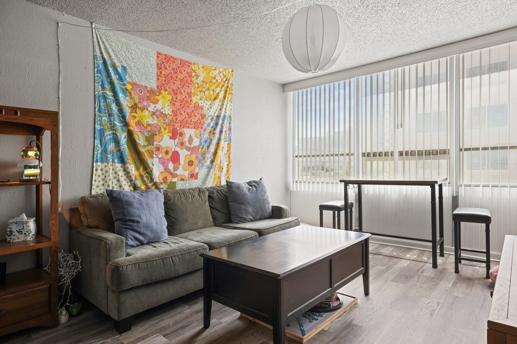 1800 Lavaca Street, Unit 207 Austin, TX 78701 - Photo 17 of 24 Living area with wood finished floors and a textured ceiling