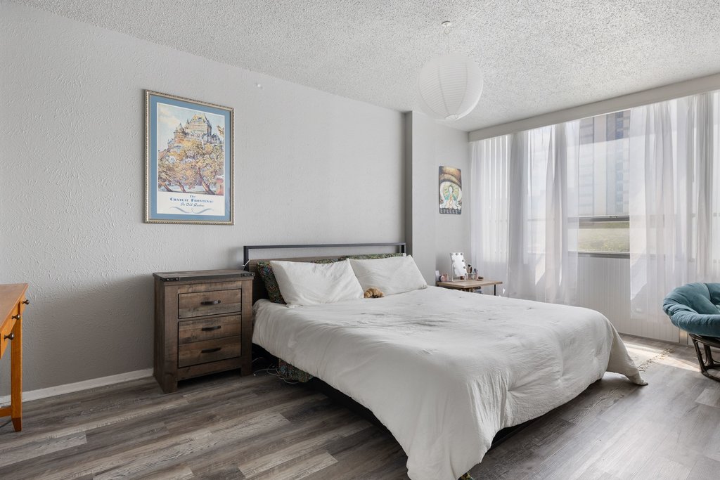 1800 Lavaca Street, Unit 207 Austin, TX 78701 - Photo 5 of 24 Bedroom with dark wood finished floors and a textured ceiling