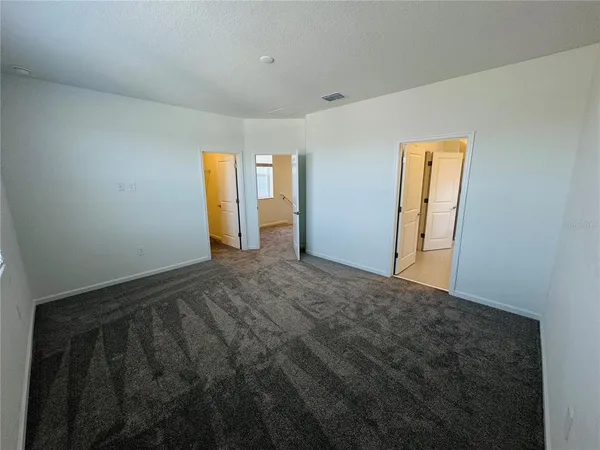 a bathroom with a double vanity sink a mirror and a bathtub