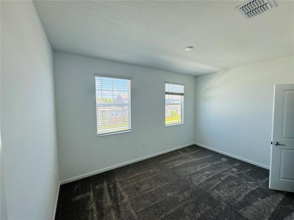 1952 Rider Rain Lane Apopka, FL 32703 - Photo 22 of 34 a view of an empty room with a window