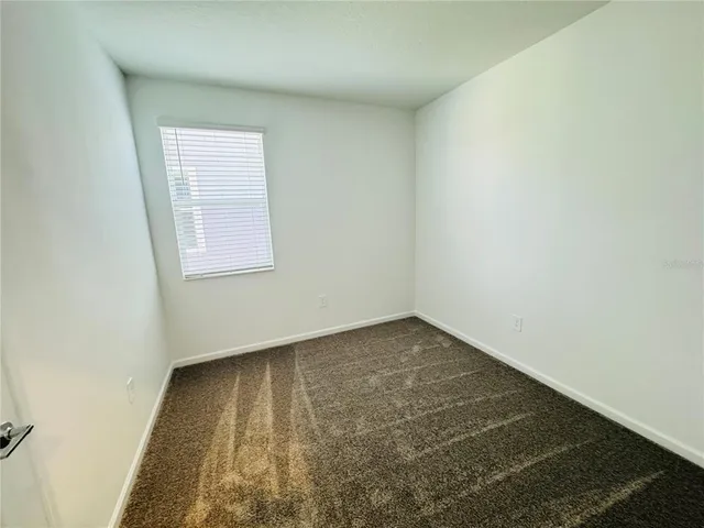 a white toilet sitting next to a bath tub and shower