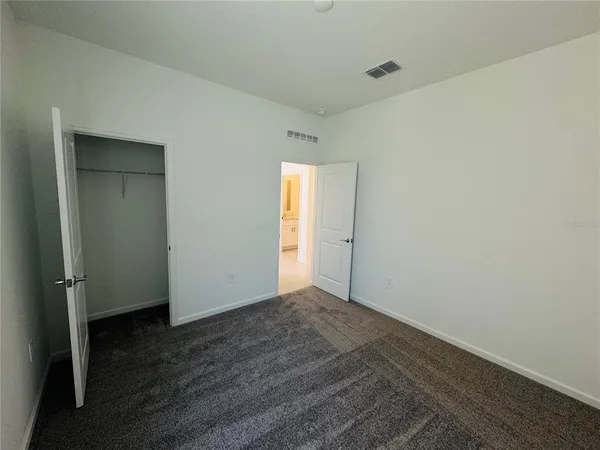 an empty room with wooden floor and closet