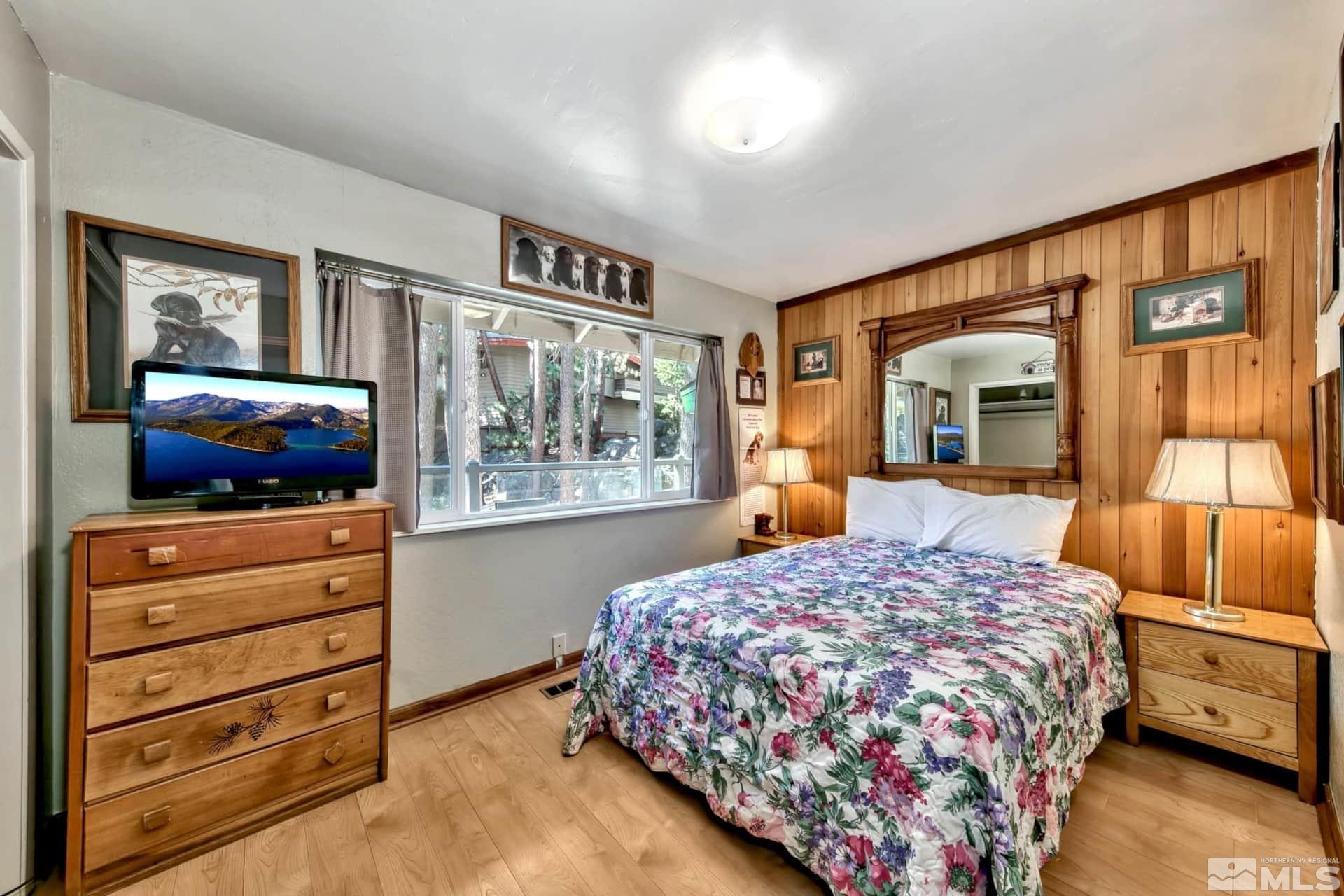 173 Juniper Drive Stateline, NV 89449 - Photo 12 of 29 a bedroom with a bed and wooden floor