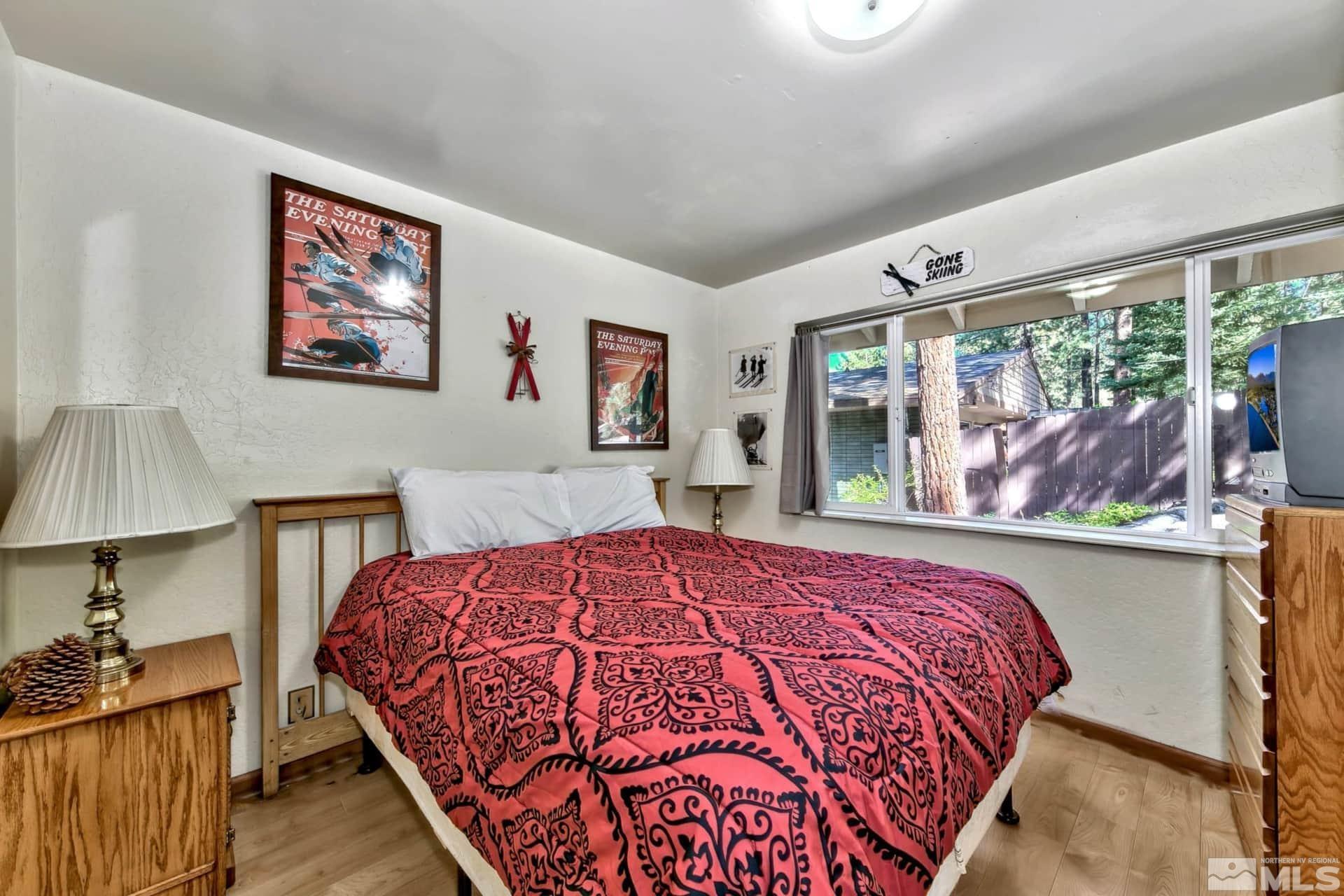 173 Juniper Drive Stateline, NV 89449 - Photo 13 of 29 a bedroom with a large bed and a window