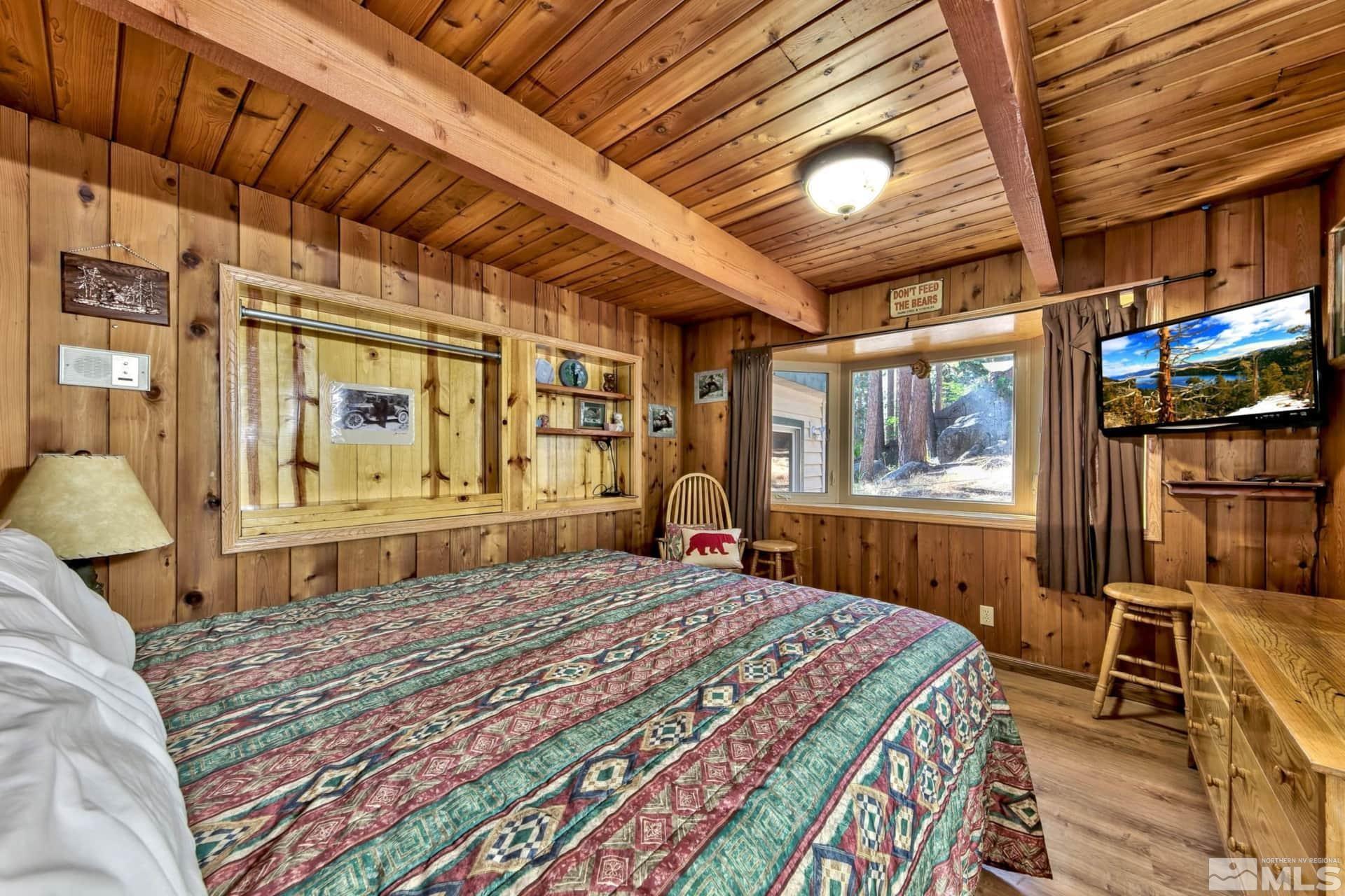 173 Juniper Drive Stateline, NV 89449 - Photo 14 of 29 a bedroom with a bed next to a window with outer view