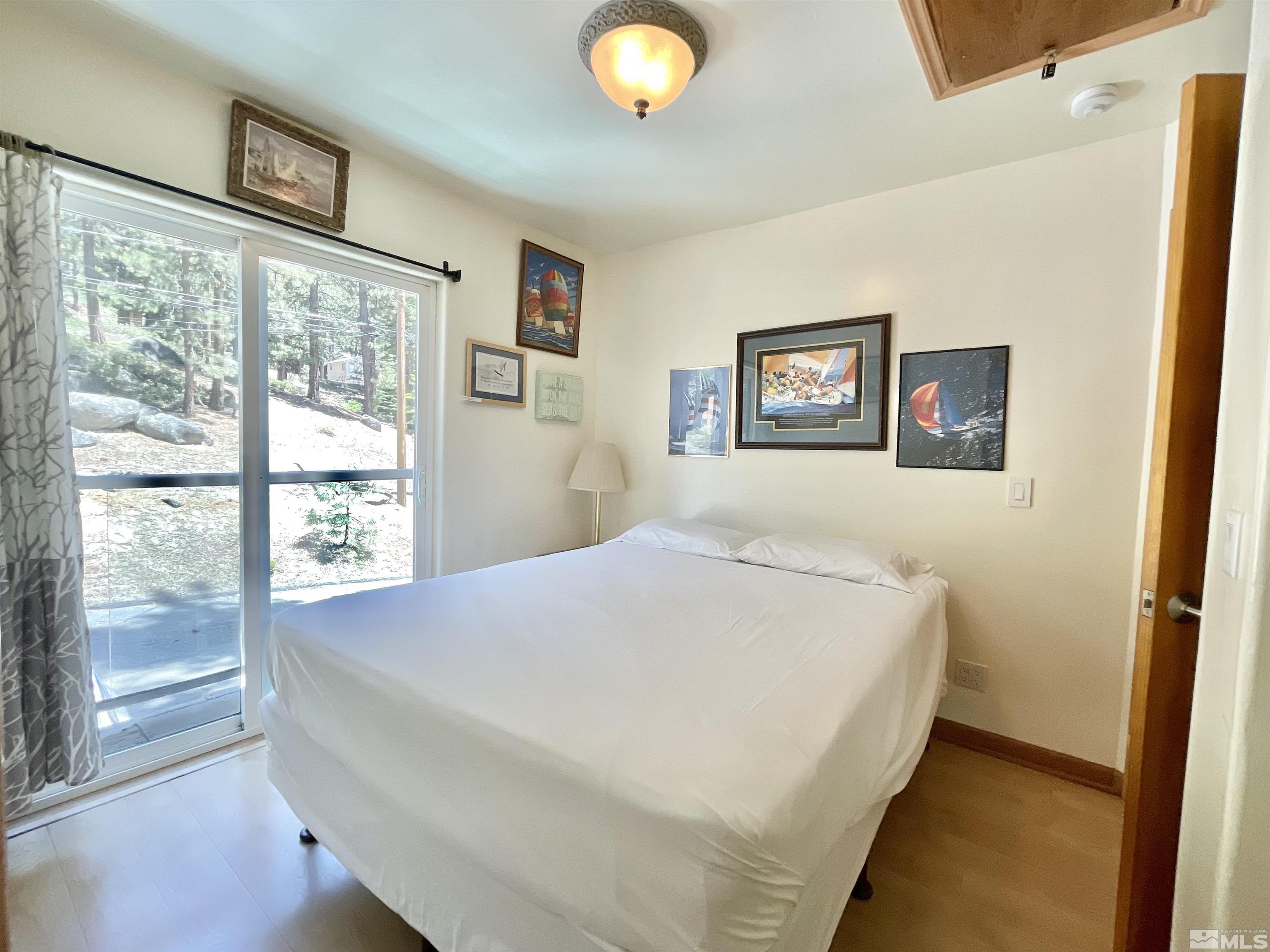 173 Juniper Drive Stateline, NV 89449 - Photo 17 of 29 a bedroom with a bed and a large window