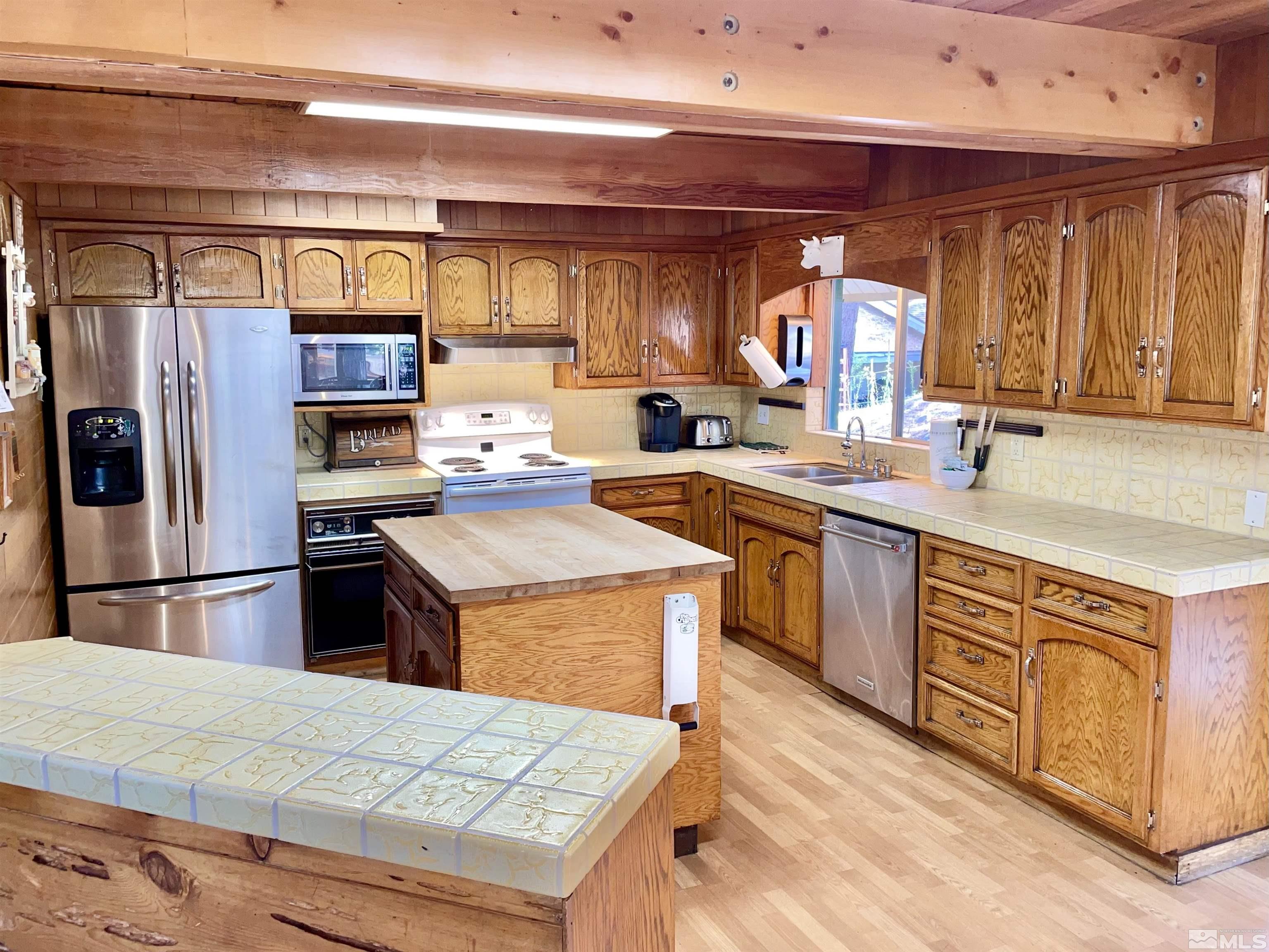 173 Juniper Drive Stateline, NV 89449 - Photo 5 of 29 a kitchen with a sink refrigerator and cabinets
