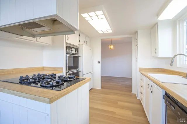 a kitchen with stainless steel appliances granite countertop a sink and cabinets