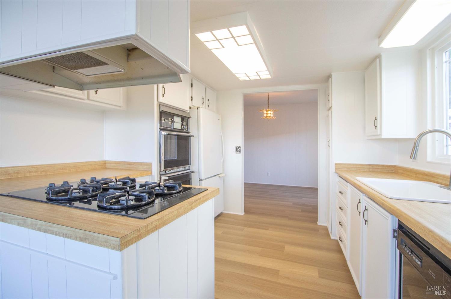 10 Fallen Leaf Way Novato, CA 94949 - Photo 11 of 30 a kitchen with stainless steel appliances granite countertop a sink and cabinets