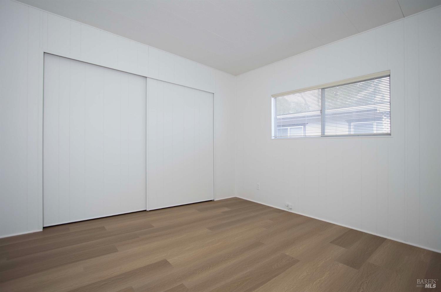 10 Fallen Leaf Way Novato, CA 94949 - Photo 14 of 30 an empty room with wooden floor and windows